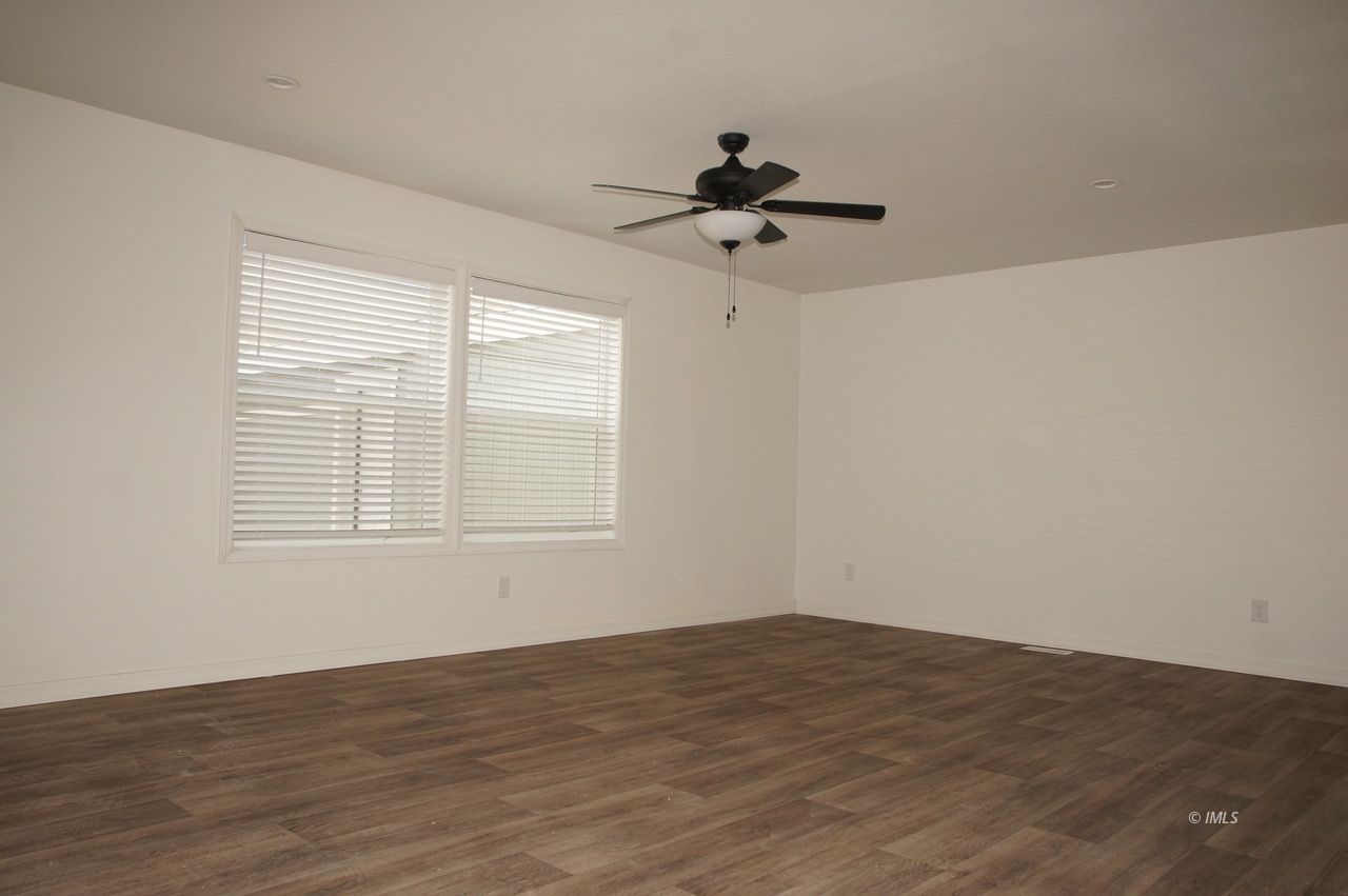 161 Tuolumne Road Bishop, CA 93514 - Photo 6 of 23 a view of empty room with wooden floor and fan