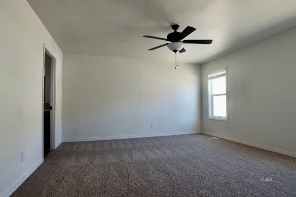 a view of room with a ceiling fan