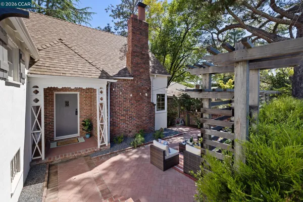 a view of a house with backyard sitting area and garden