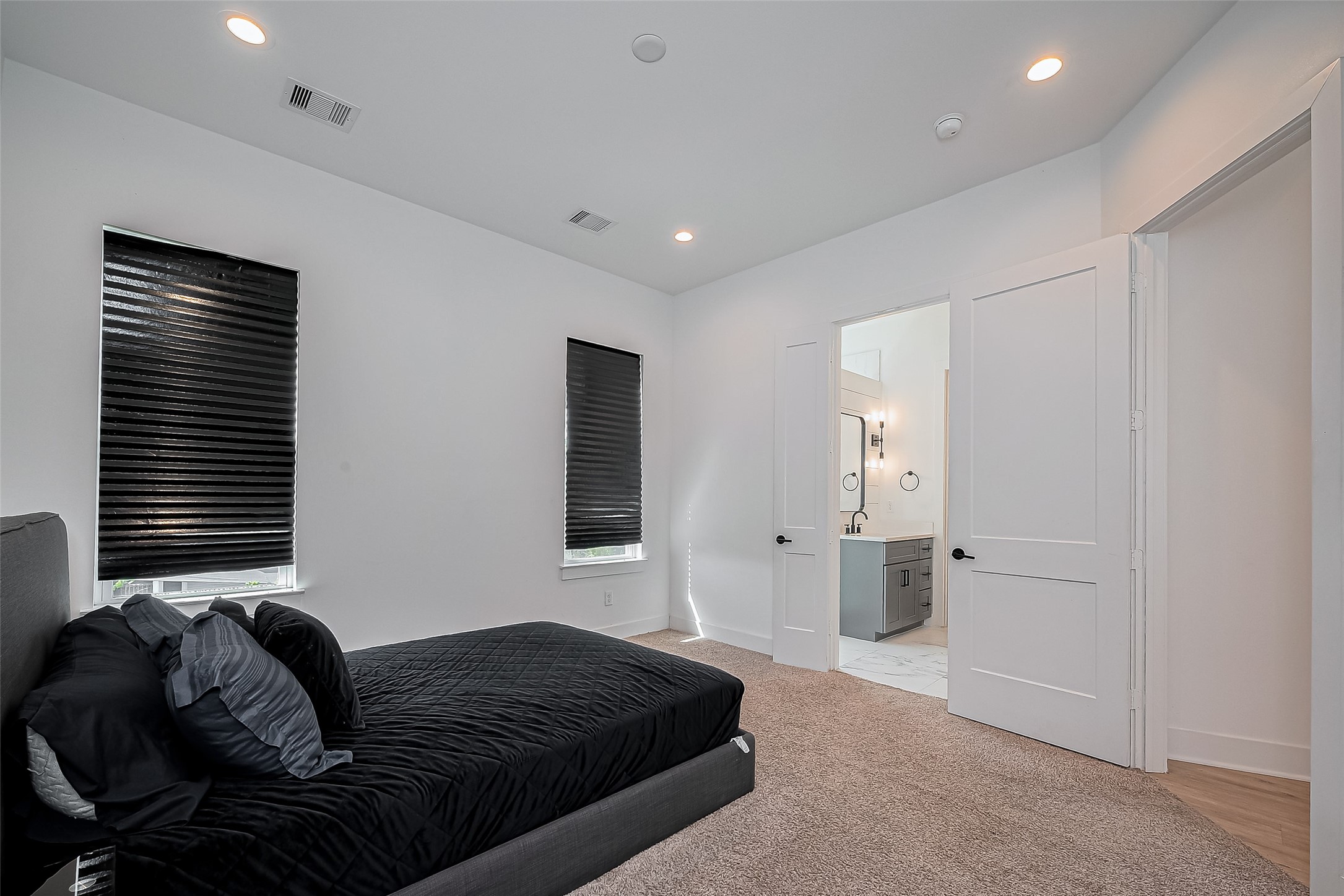 2518 Terry Street Houston, TX 77009 - Photo 12 of 17 Spacious bedroom suite featuring plush carpet flooring, recessed lighting, private ensuite bath access, and a generous walk-in closet.