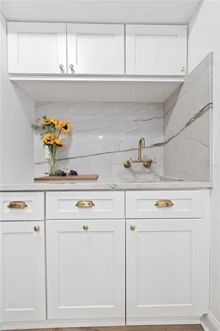 a sink with white cabinets