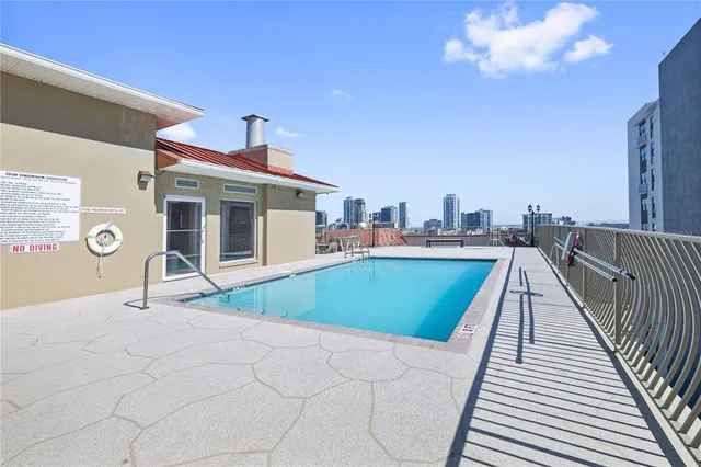 a house view with a swimming pool and seating space