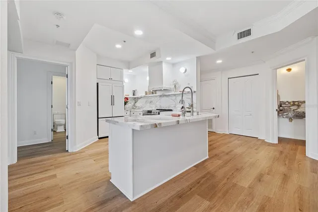 a view of kitchen with stainless steel appliances refrigerator stove microwave and cabinets