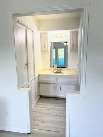 a bathroom with a double vanity sink mirror and toilet