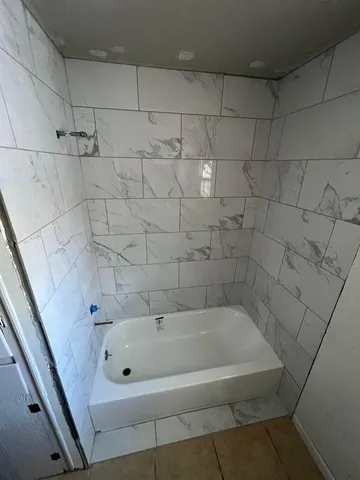 a white bath tub sitting in a bathroom