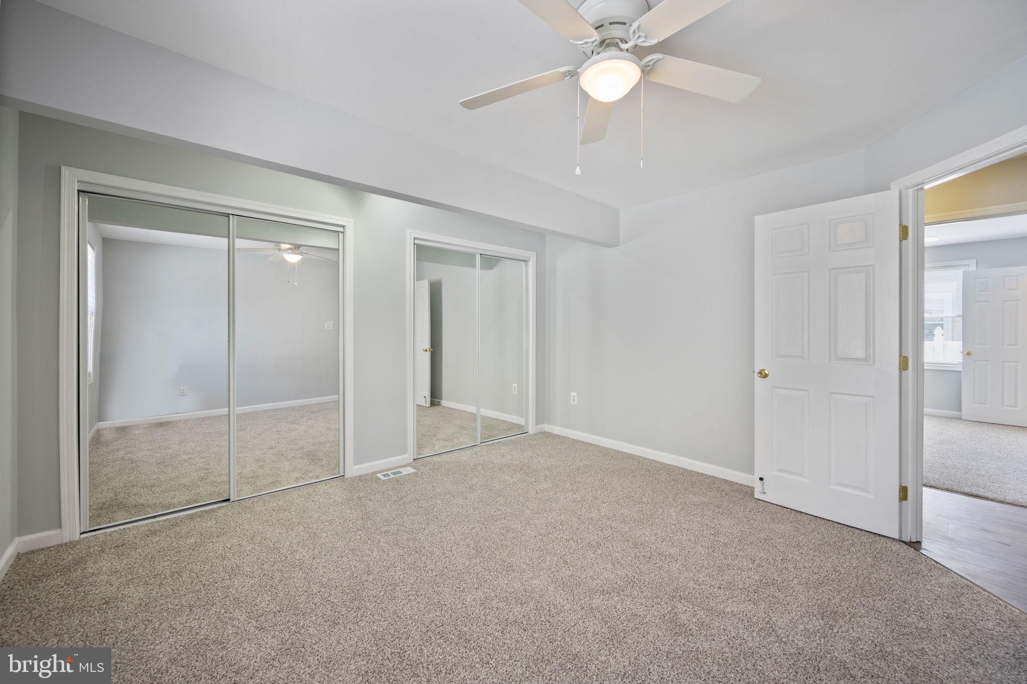 8626 Wise Avenue Baltimore, MD 21222 - Photo 21 of 57 an empty room with closet and a chandelier fan