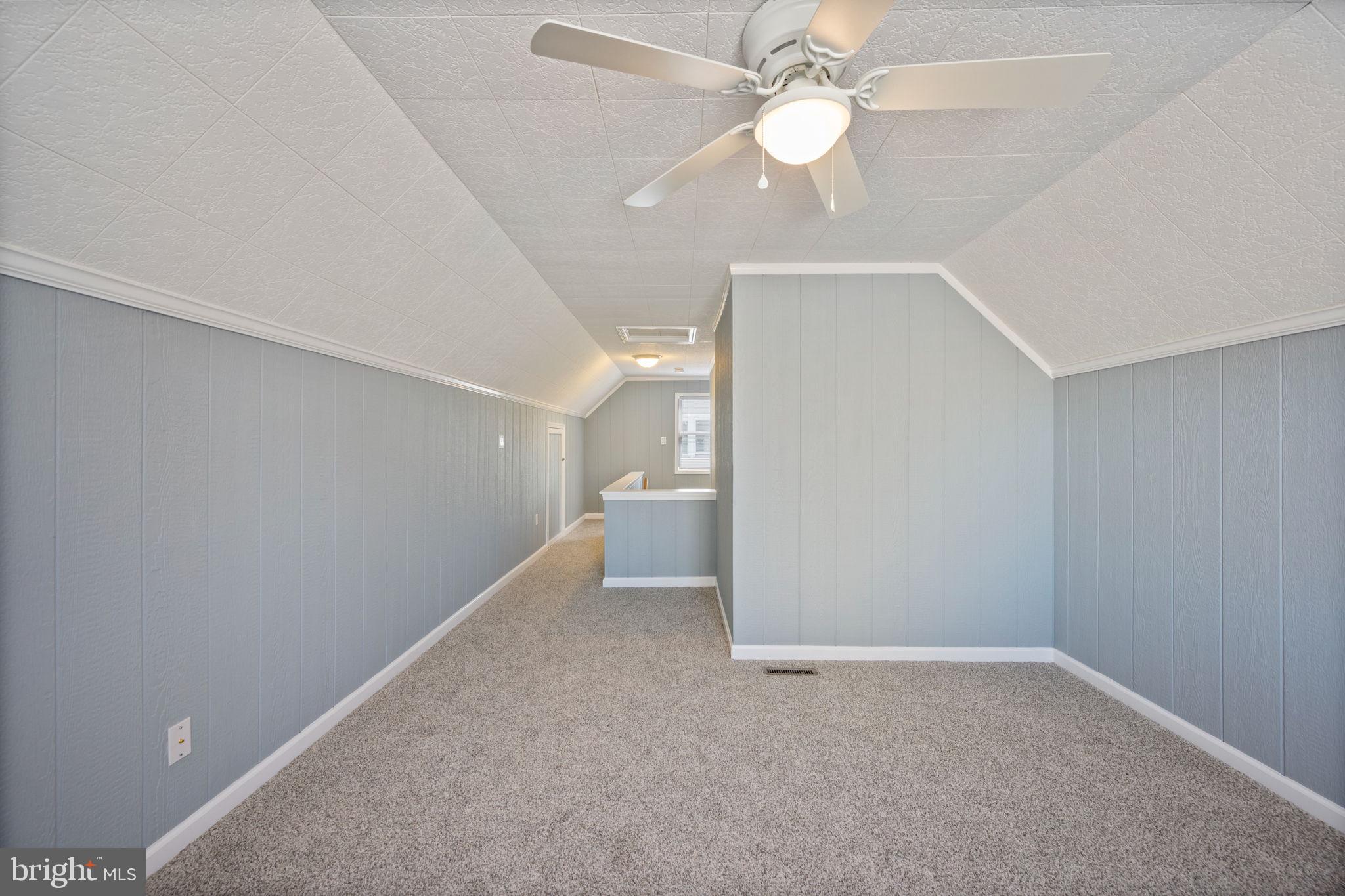 8626 Wise Avenue Baltimore, MD 21222 - Photo 27 of 57 an empty room with a ceiling fan and a fan