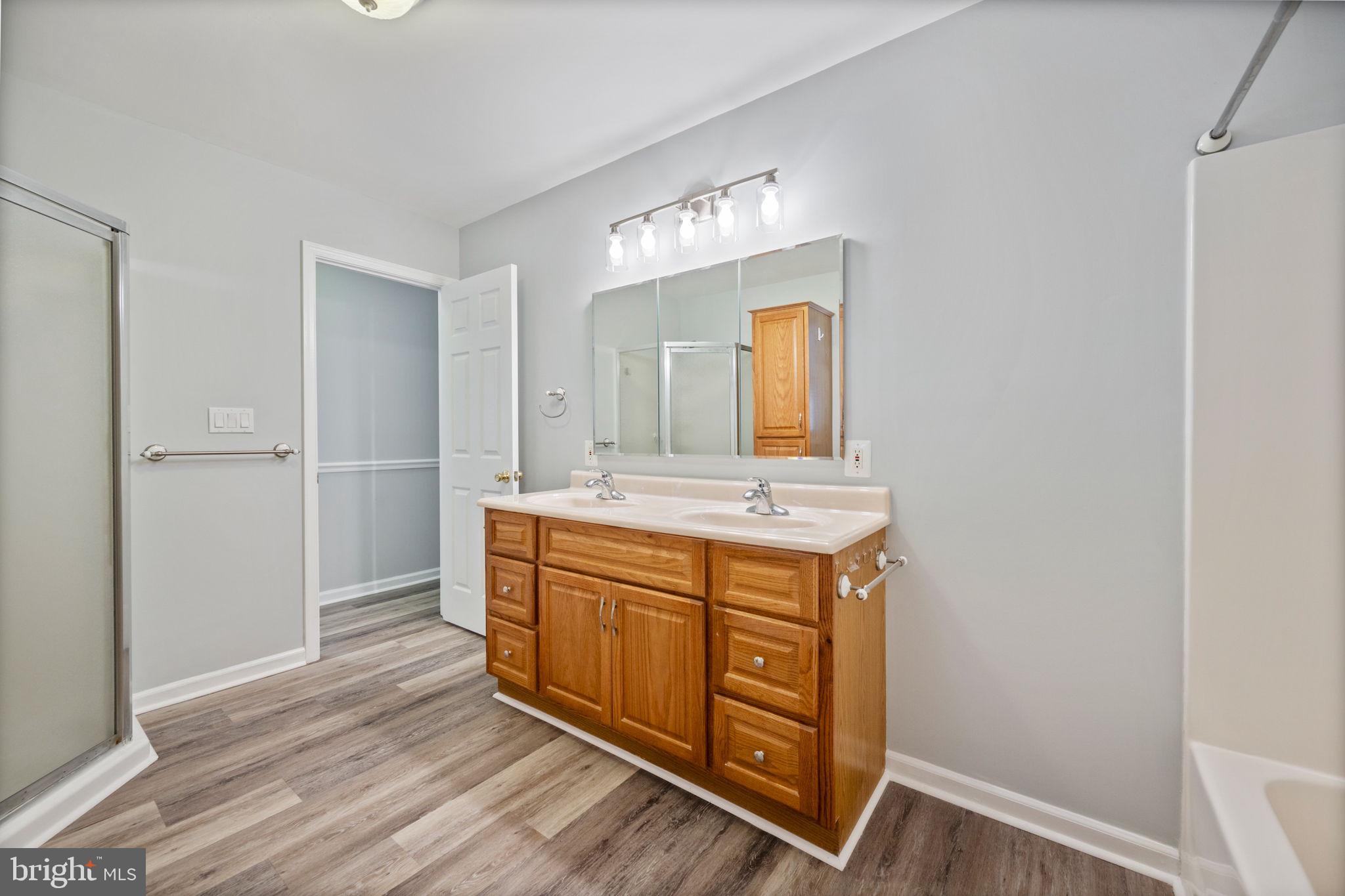 8626 Wise Avenue Baltimore, MD 21222 - Photo 33 of 57 a spacious bathroom with a double vanity sink and a mirror