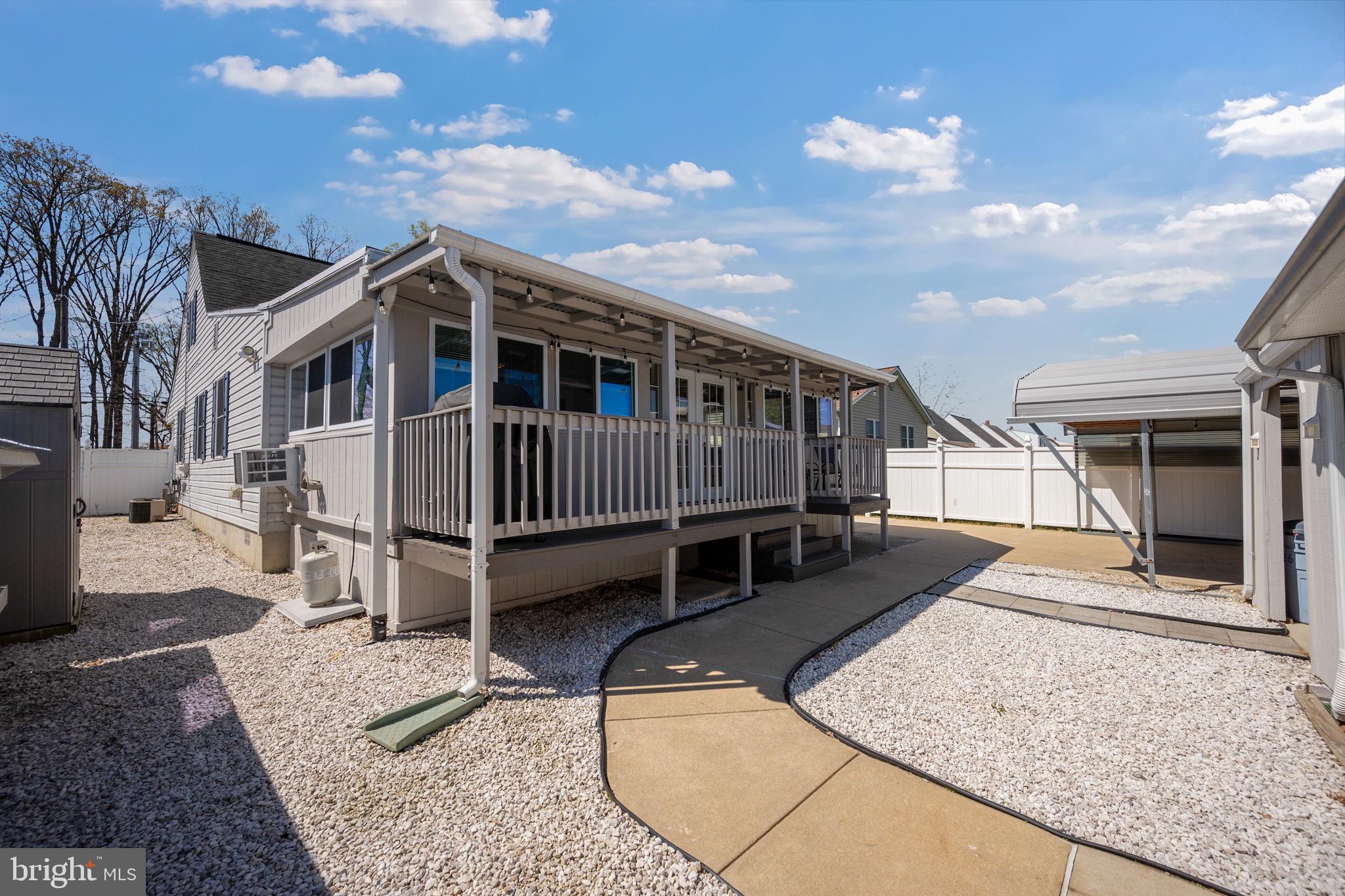 8626 Wise Avenue Baltimore, MD 21222 - Photo 40 of 57 a view of a house with wooden deck and a backyard