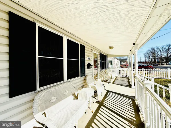a view of balcony with wooden floor and seating space
