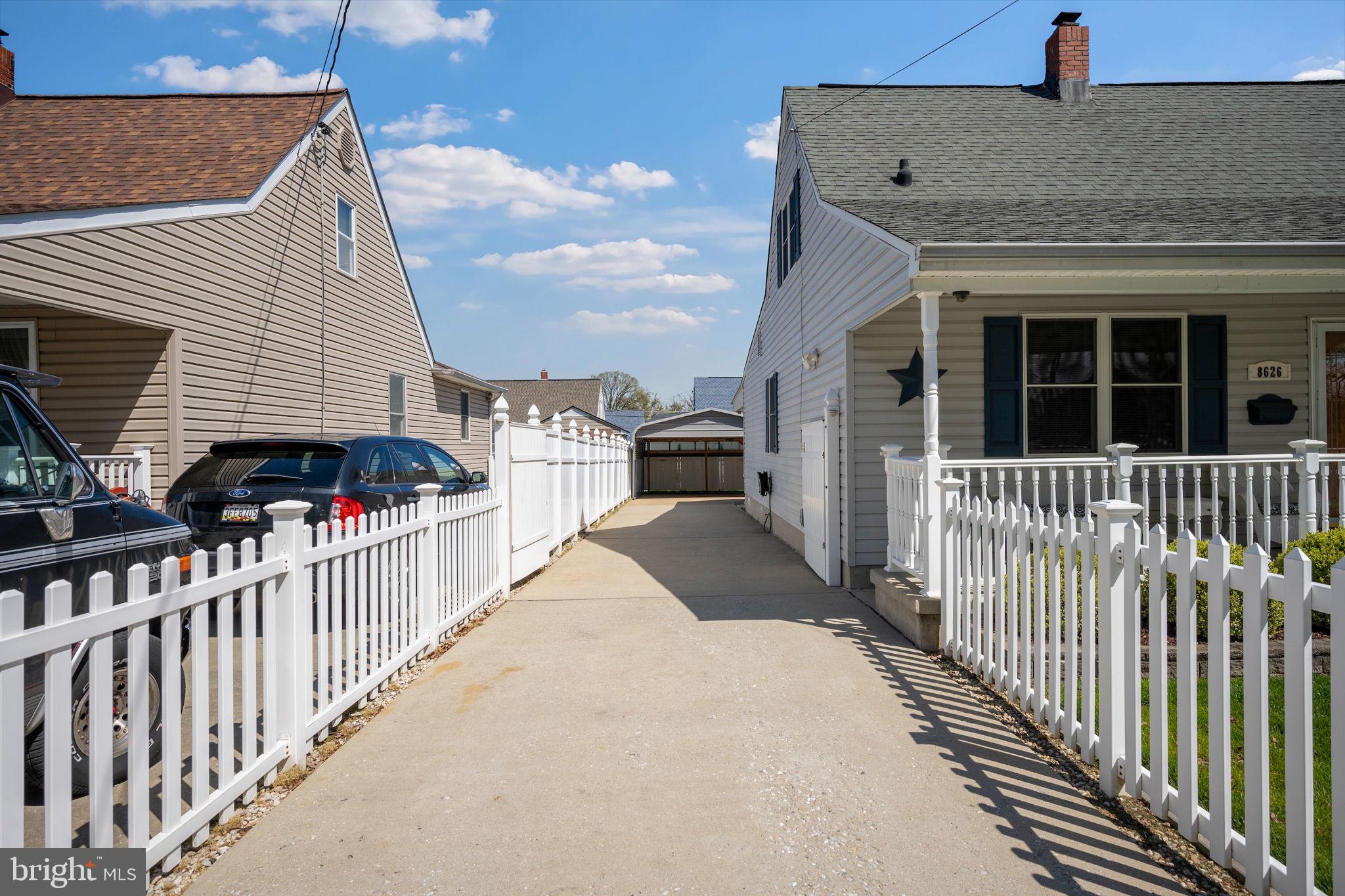 8626 Wise Avenue Baltimore, MD 21222 - Photo 50 of 57 a view of a house with a small yard and wooden fence