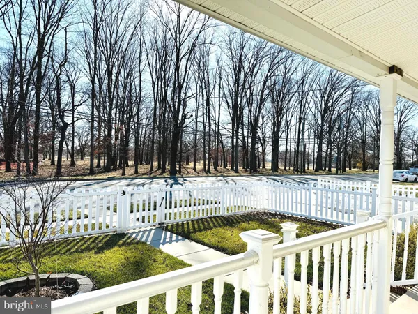 a view of street with wooden fence