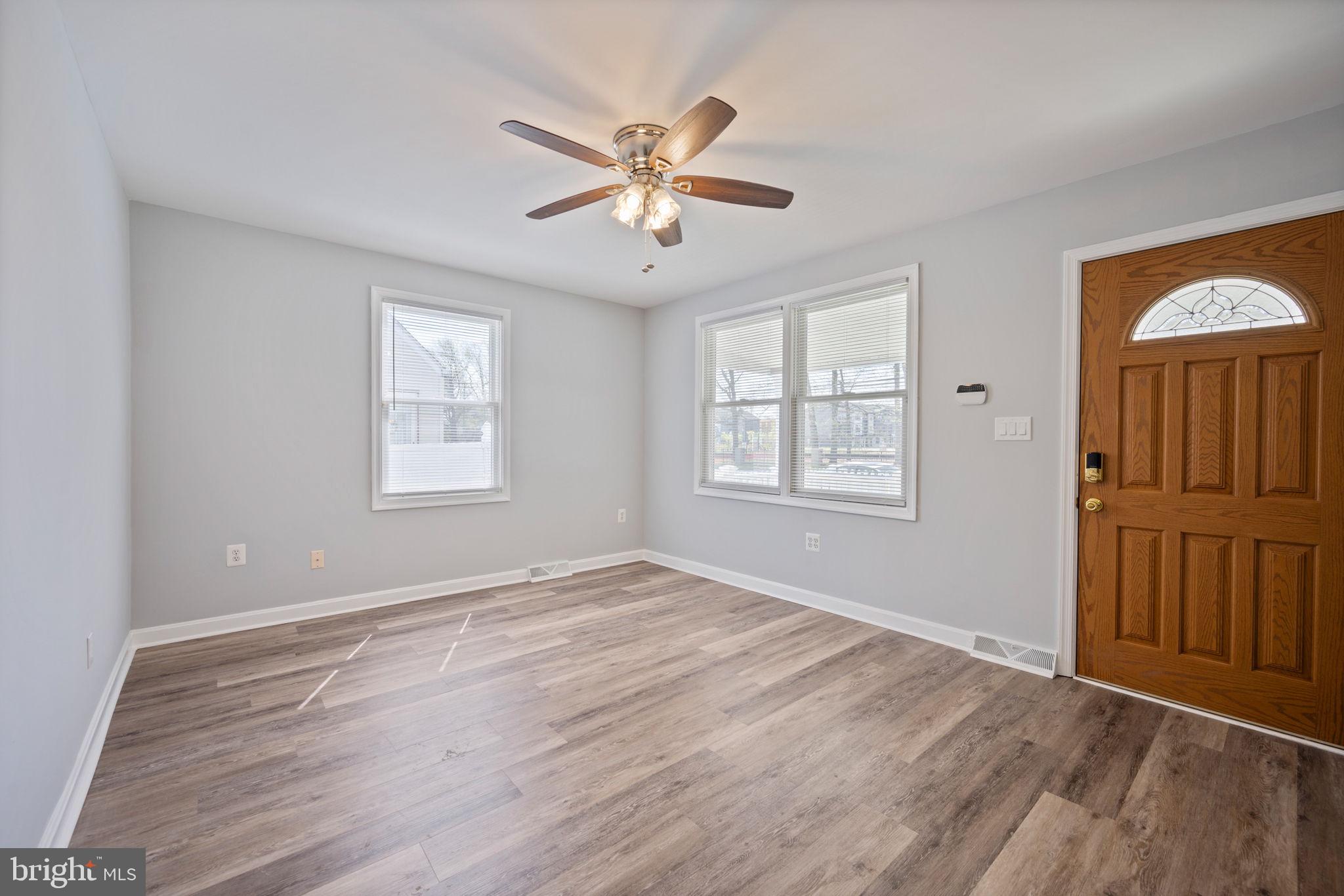8626 Wise Avenue Baltimore, MD 21222 - Photo 10 of 57 a view of an empty room with window and wooden floor
