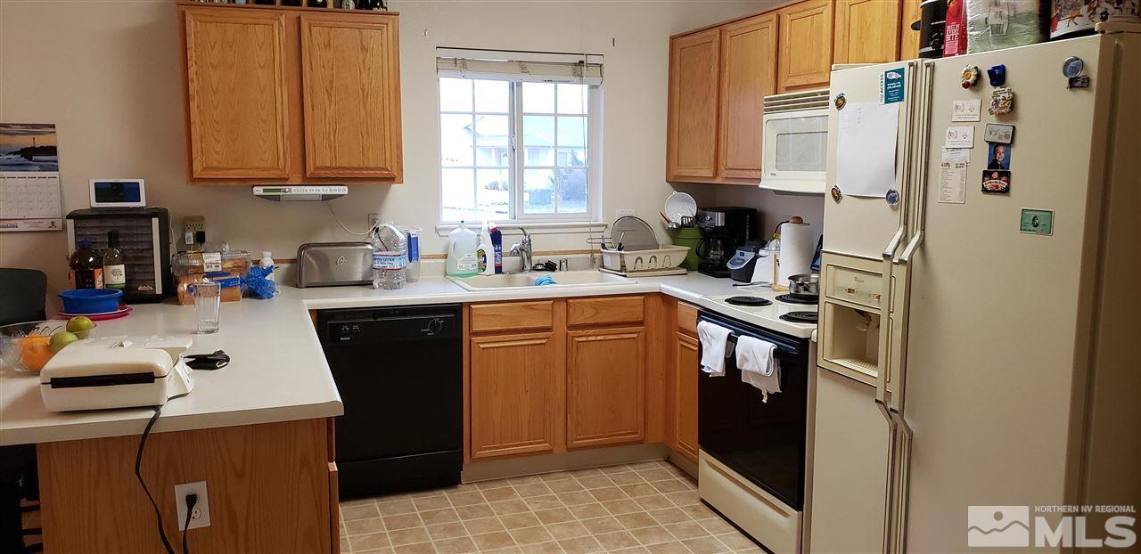 85 Calistoga Court Reno, NV 89508 - Photo 17 of 23 a kitchen with a sink a stove and refrigerator