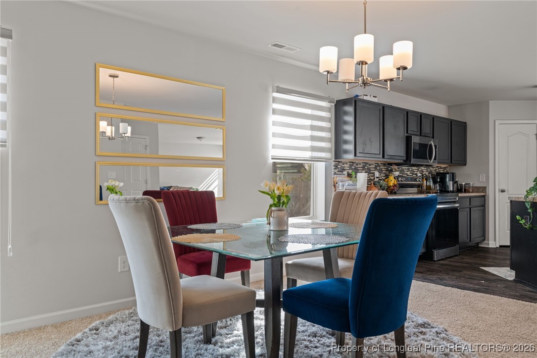 287 Hallow Oak Street Spring Lake, NC 28390 - Photo 1 of 37 a view of a dining room with furniture window and wooden floor