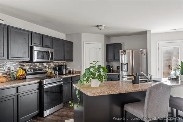 a kitchen with granite countertop a sink and cabinets