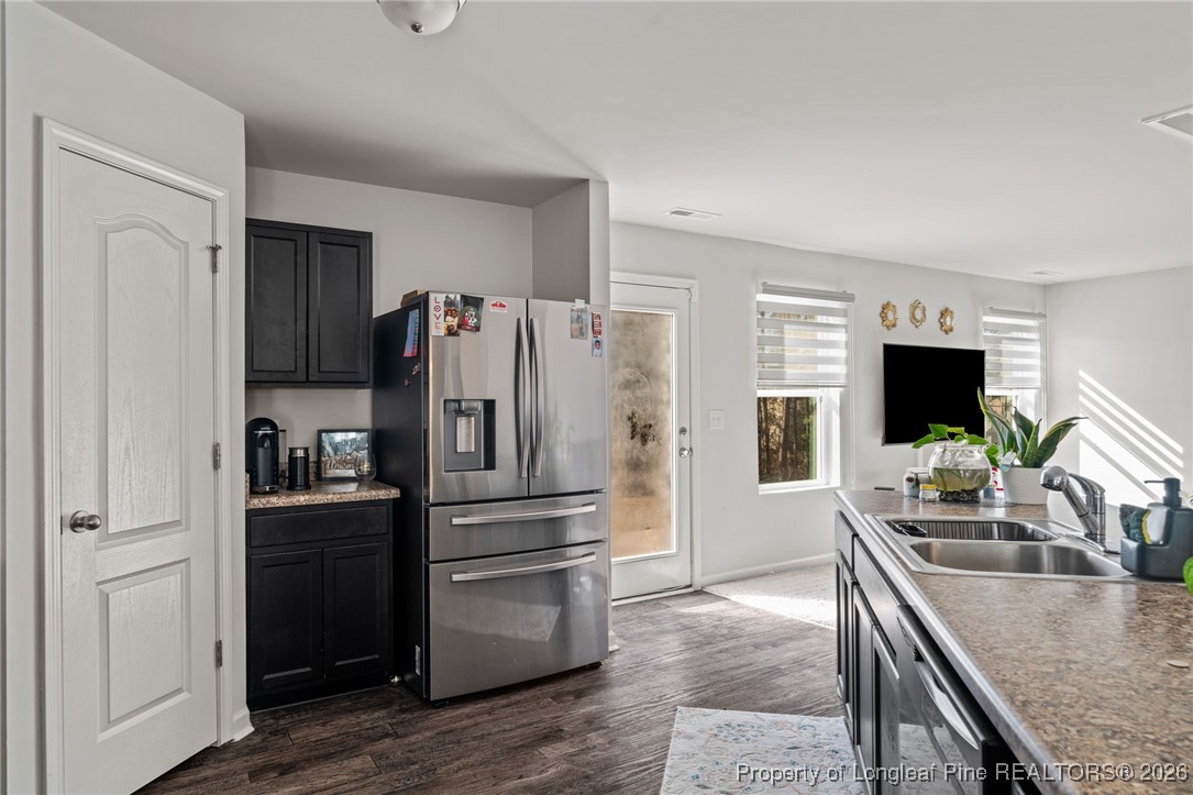 287 Hallow Oak Street Spring Lake, NC 28390 - Photo 15 of 37 a kitchen with granite countertop a refrigerator stove and sink