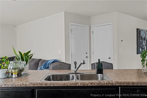 a view of living room with granite countertop couches with wooden floor