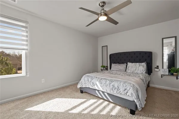 a bedroom with a large bed and a window