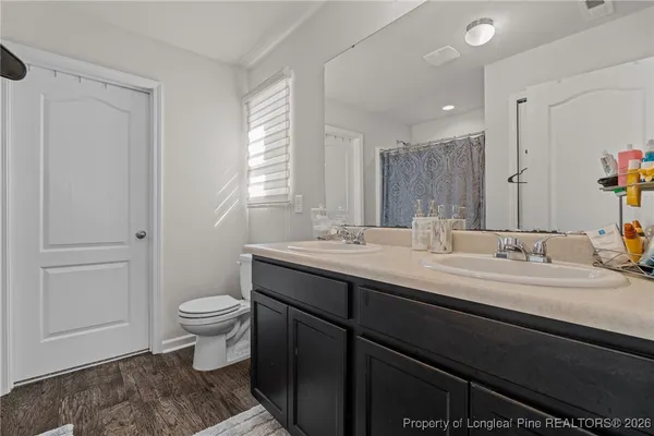 a bathroom with a sink toilet and mirror