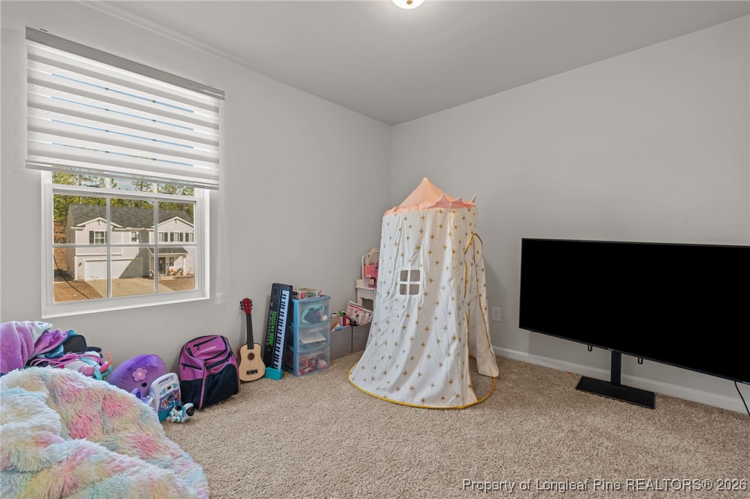 287 Hallow Oak Street Spring Lake, NC 28390 - Photo 30 of 37 a living room with furniture and a flat screen tv