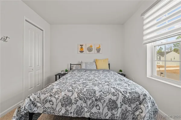 a bedroom with a bed and a window