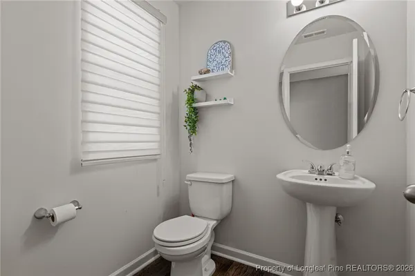 a bathroom with a sink toilet and a mirror