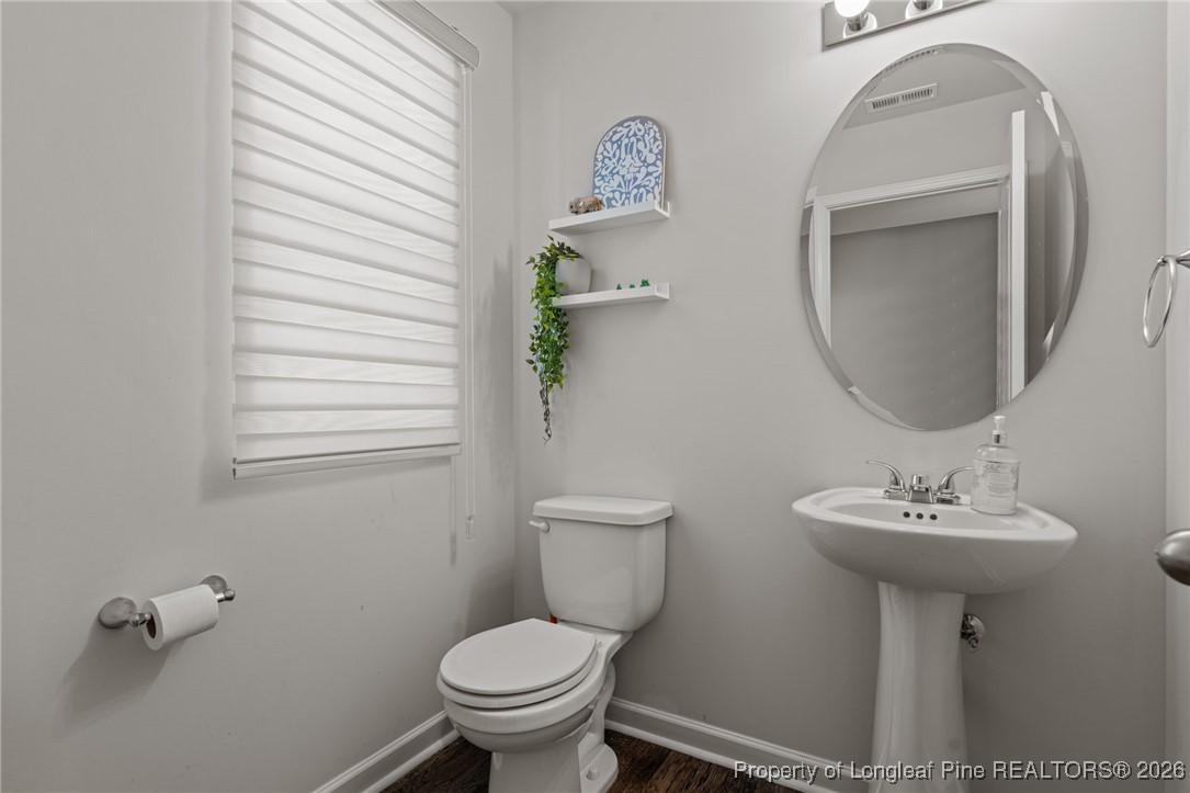 287 Hallow Oak Street Spring Lake, NC 28390 - Photo 9 of 37 a bathroom with a sink toilet and a mirror
