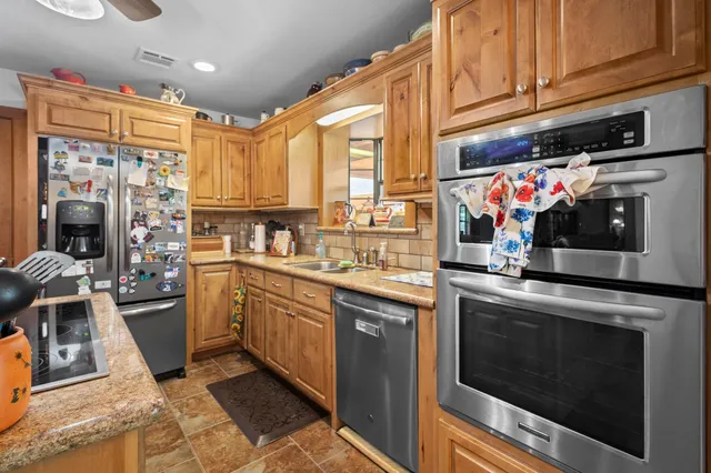 a spacious bedroom with a bed and wooden floor
