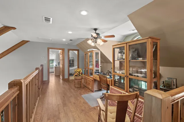 a view of a dining room with furniture and a chandelier fan