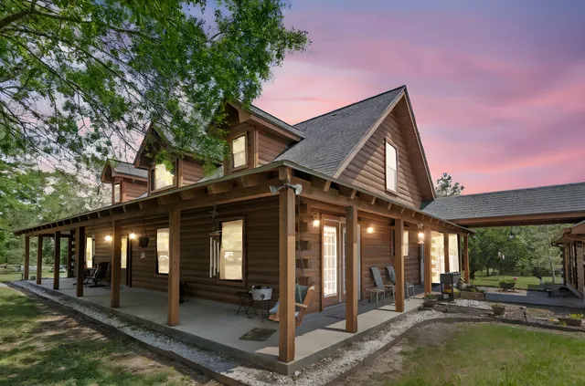 a view of a house with backyard porch and sitting area