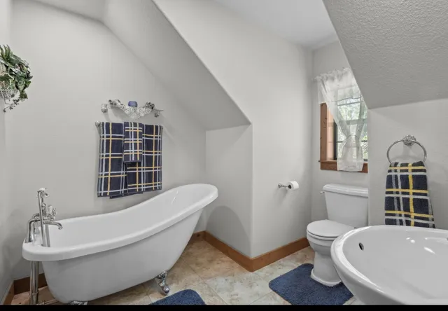 a view of a workspace with furniture and a book shelf
