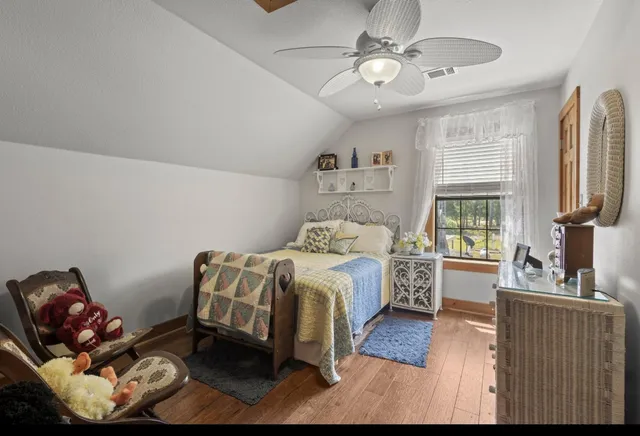 a view of a park with a house in the background