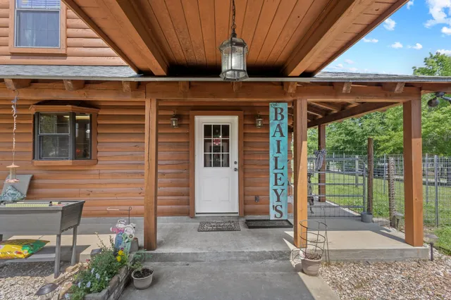 a view of a porch with furniture and floor to ceiling window