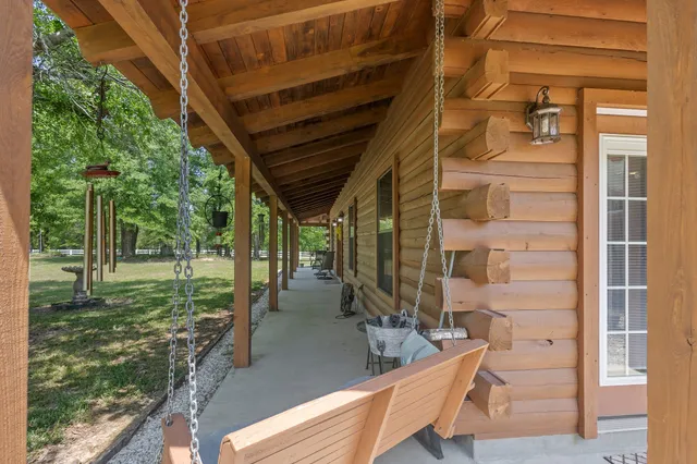 a view of hallway with livingroom and wooden floor