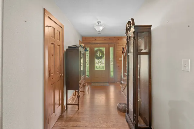 a living room with furniture a chandelier and a fireplace