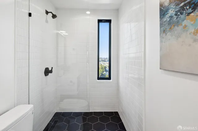 a bedroom with a bed and a lamp on table