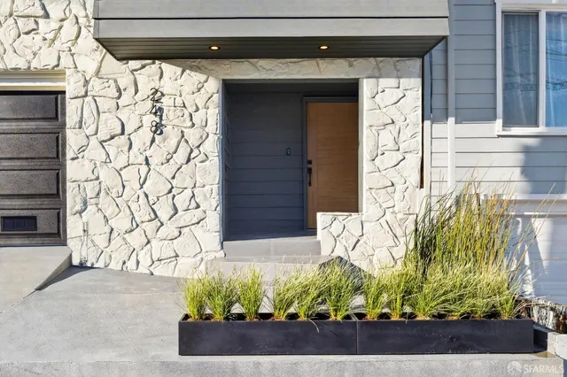a view of entryway with wooden floor and stairs
