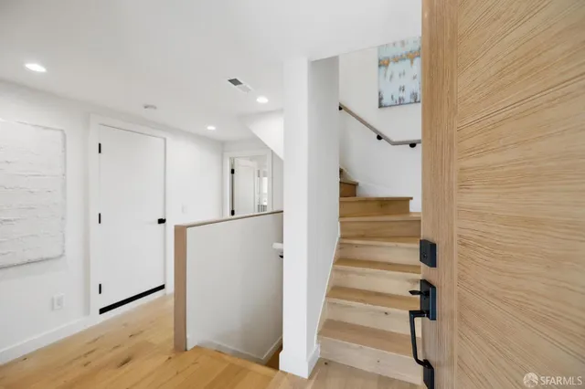 a view of kitchen with stainless steel appliances granite countertop a refrigerator and a sink