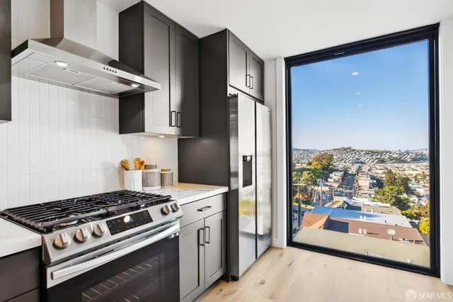 a kitchen with a sink cabinets and appliances