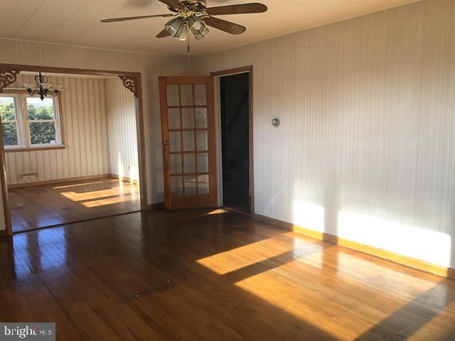 472 Richards Road Bridgeton, NJ 08302 - Photo 8 of 21 a view of an empty room with window and wooden floor