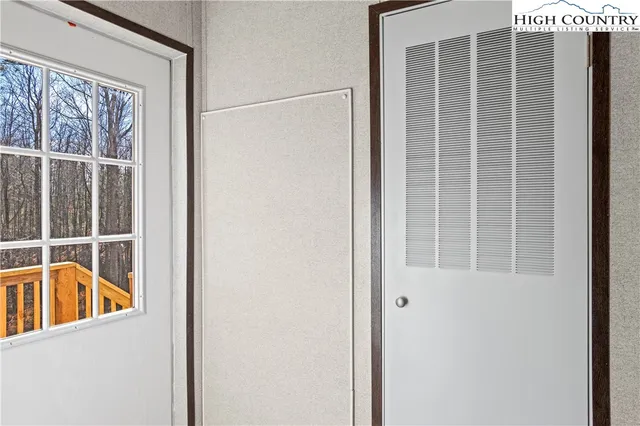 a view of an empty room and a window