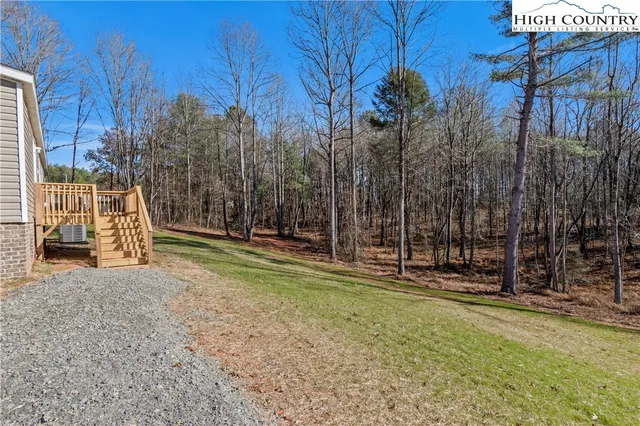 a view of a backyard with iron fence