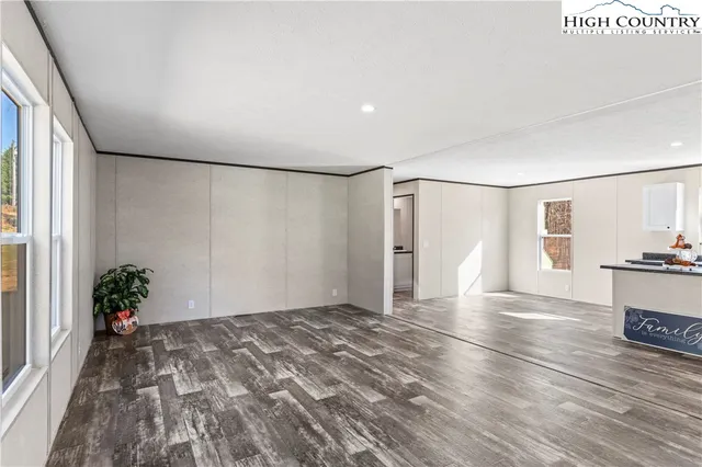 a view of a room with wooden floor and potted plants
