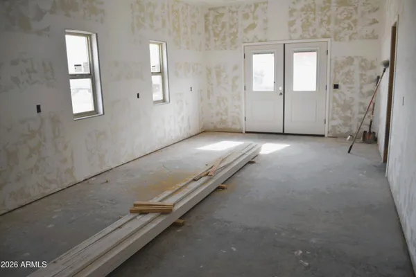an empty room with windows and yard