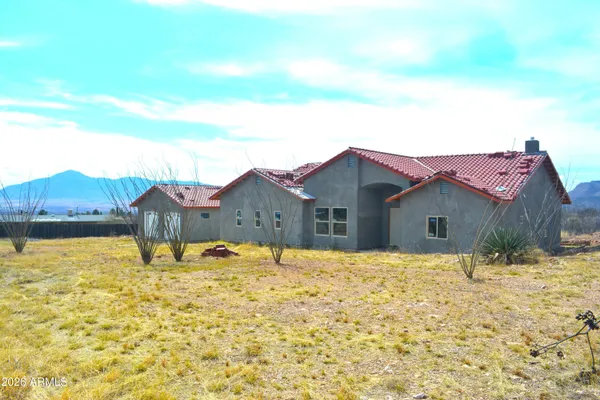a house view with a covered with snow in front of it