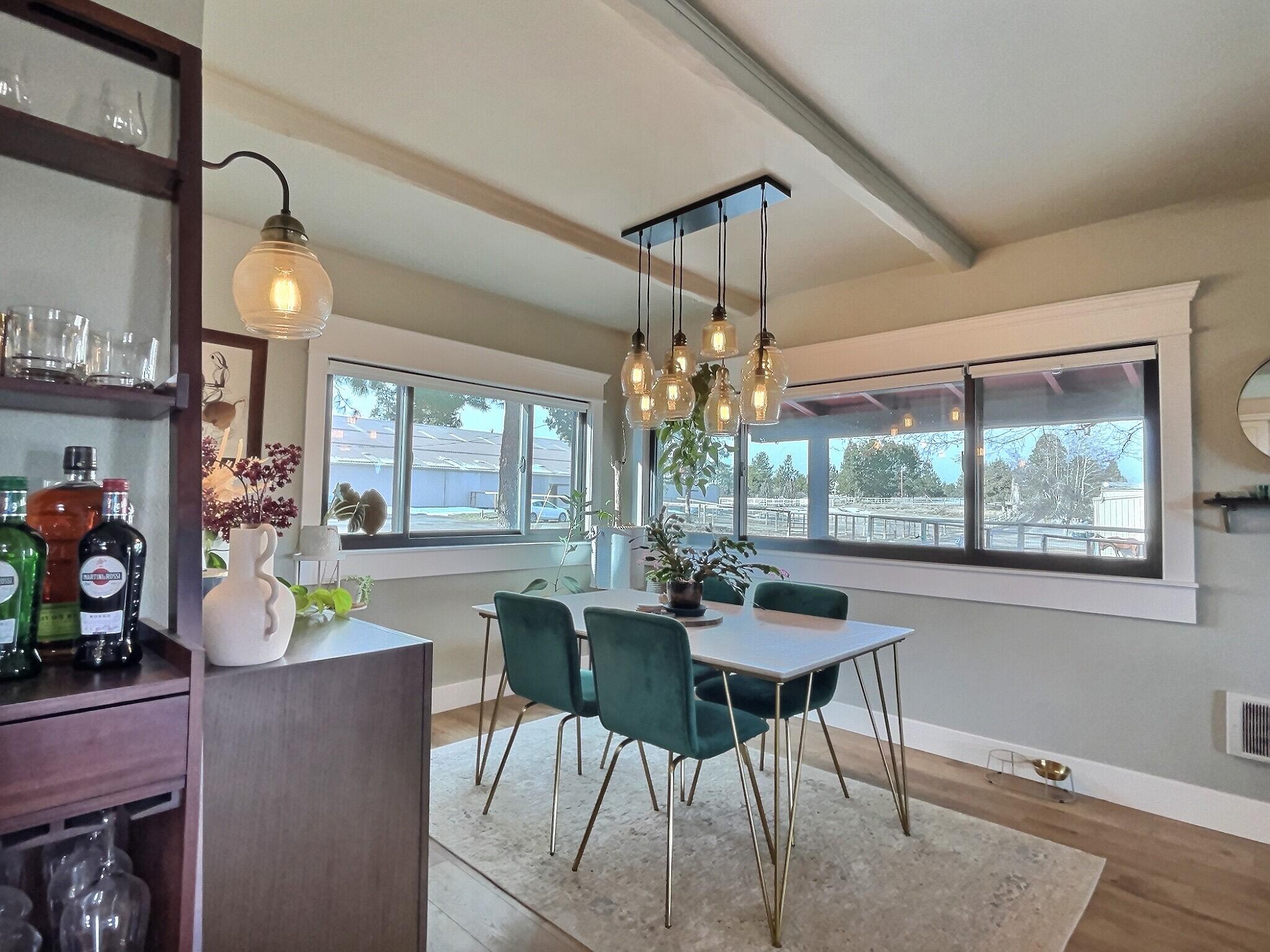 60360 Horse Butte Road Bend, OR 97702 - Photo 21 of 58 a dining room with furniture a chandelier and wooden floor