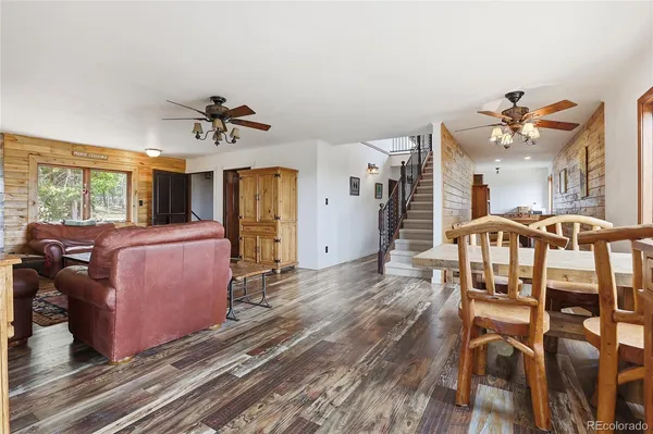 a kitchen with stainless steel appliances a refrigerator and wooden floor