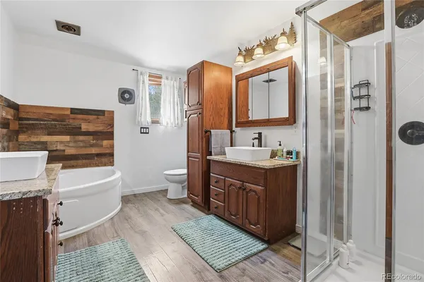 a view of a house with wooden fence next to a road