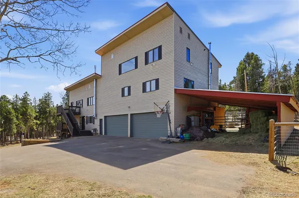 a living room with furniture a chandelier and a flat screen tv
